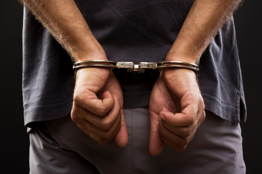 Man with handcuffs behind his back