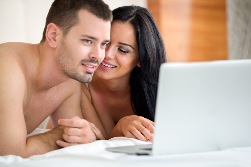 Couple look at a laptop